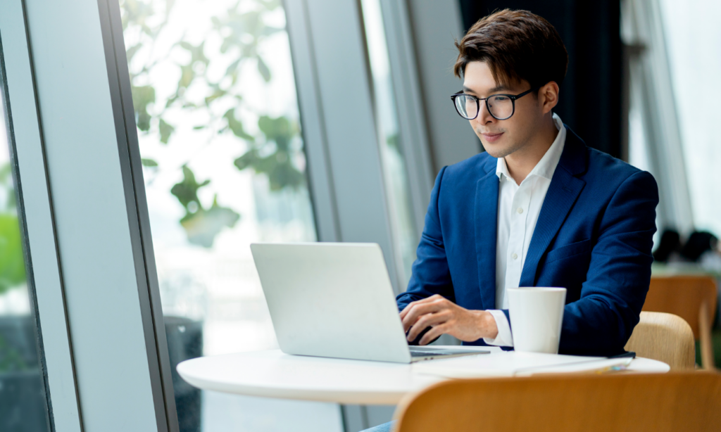 Man typing on laptop.