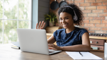 Person waving hi to a laptop.