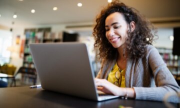 woman smiling at laptop