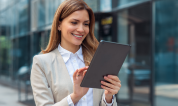 Female smiling at tablet