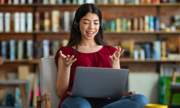 Female talking into laptop