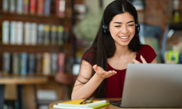 Female talking into laptop