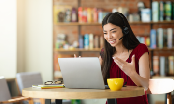 Female talking into laptop