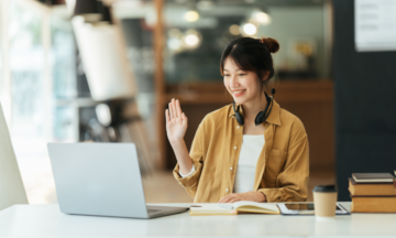 Female waving at laptop