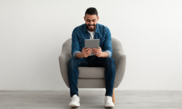 Man smiling at tablet